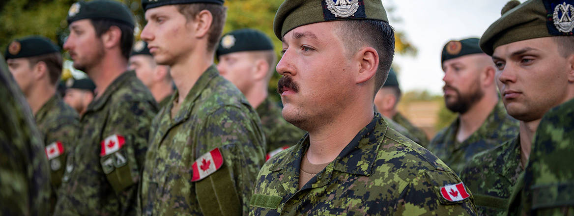 Members of the Canadian Armed Forces alongside soldiers of the British Army, Lithuanian Land Forces, and the Armed Forces of Ukraine stand on parade to celebrate the Day of the National Flag of Ukraine during Operation UNIFIER in the United Kingdom on August 23, 2023