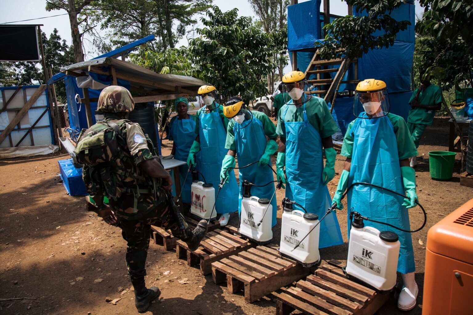 A United Nations peacekeeper has his shoes cleaned with a chlorine solution before leaving an Ebola treatment centre in Mangina, North Kivu province, on September 1, 2019.