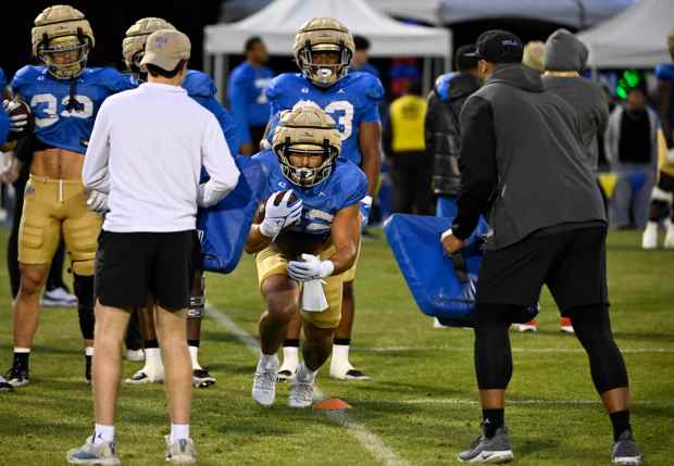 Running back Keegan Jones #22 of the UCLA Bruins during...