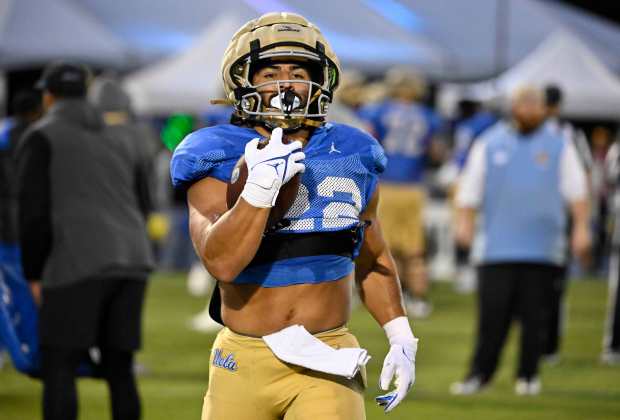 Running back Keegan Jones #22 of the UCLA Bruins during...