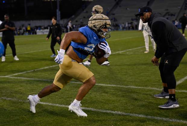 Running back Keegan Jones #22 of the UCLA Bruins during...