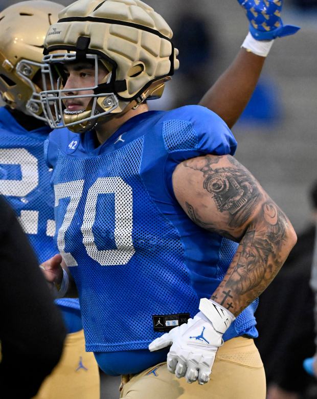 Offensive lineman Caleb Walker #70 of the UCLA Bruins during...