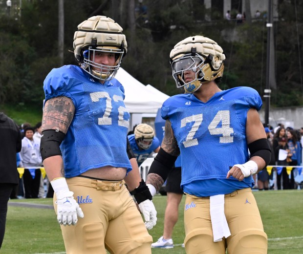Garrett DiGiorgio #72 with teammate Julian Armella of the UCLA...