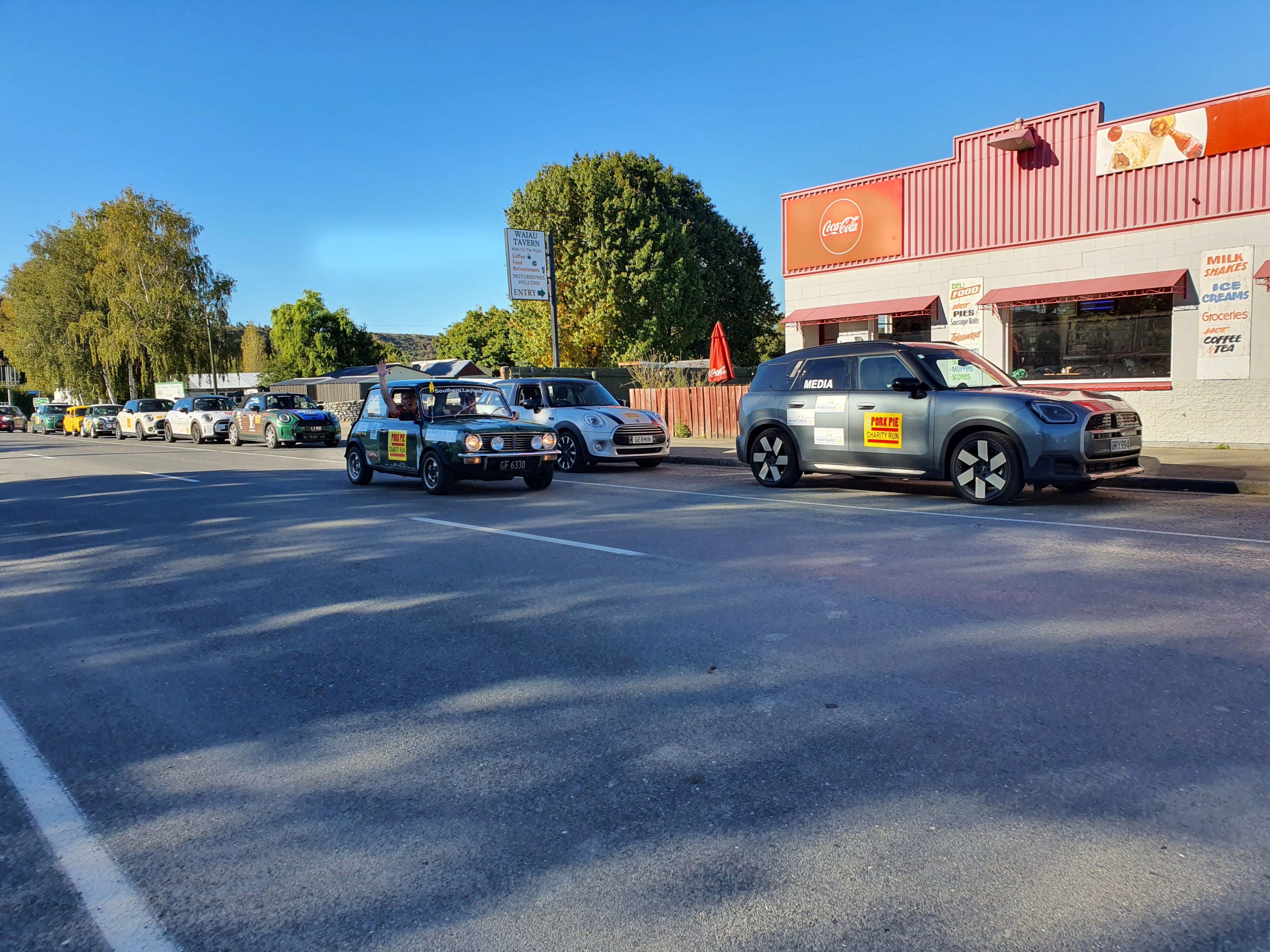 Team 'Southern Leyland Lads' pass the group of Minis outside Waiau on the 2025 Pork Pie Charity Run.
