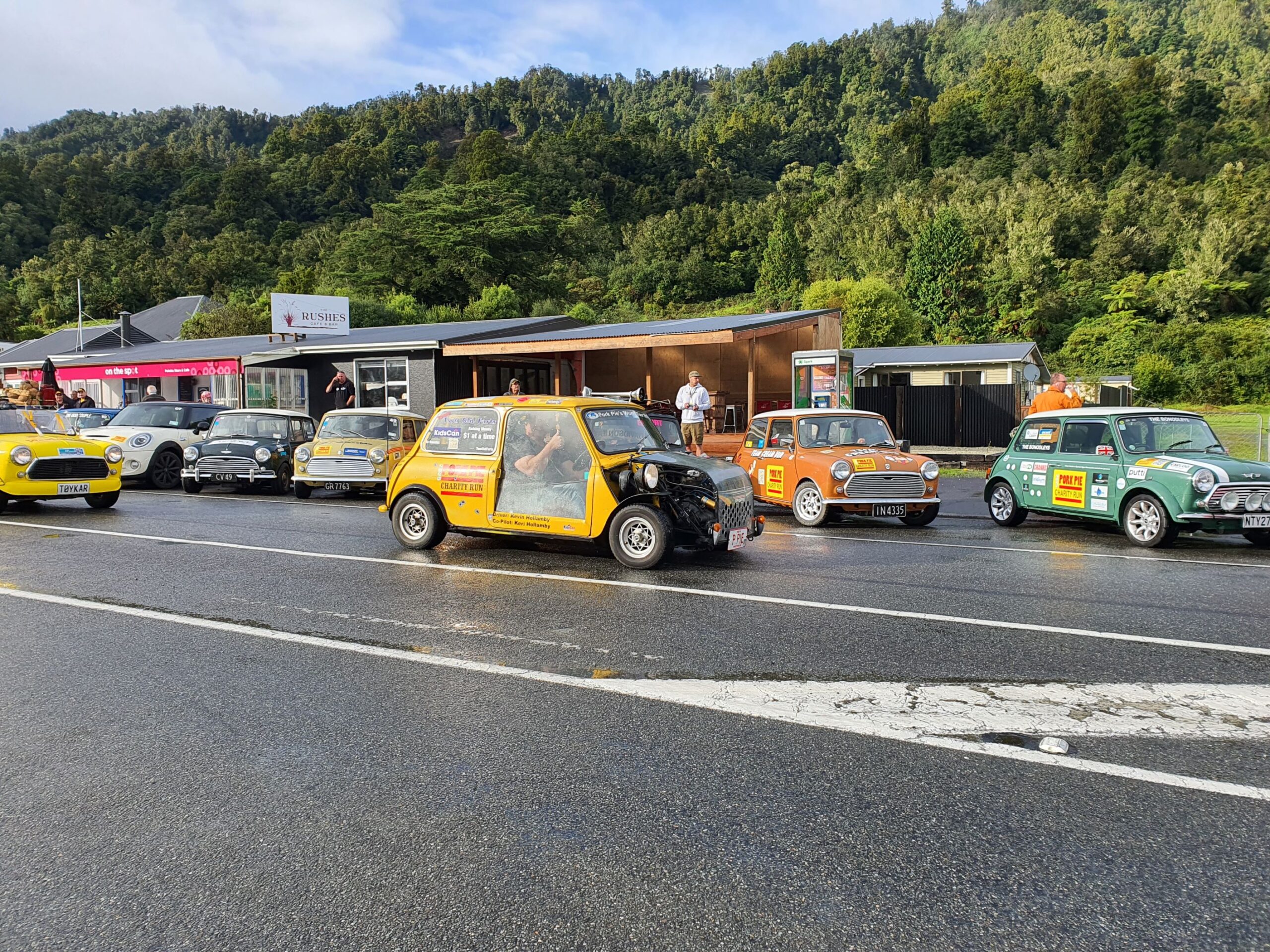 Pork Pie (Team Two Old Farts) driven by Dave McLeod of Tarmac Life passes the Minis in Harihari on the 2025 Pork Pie Charity Run.