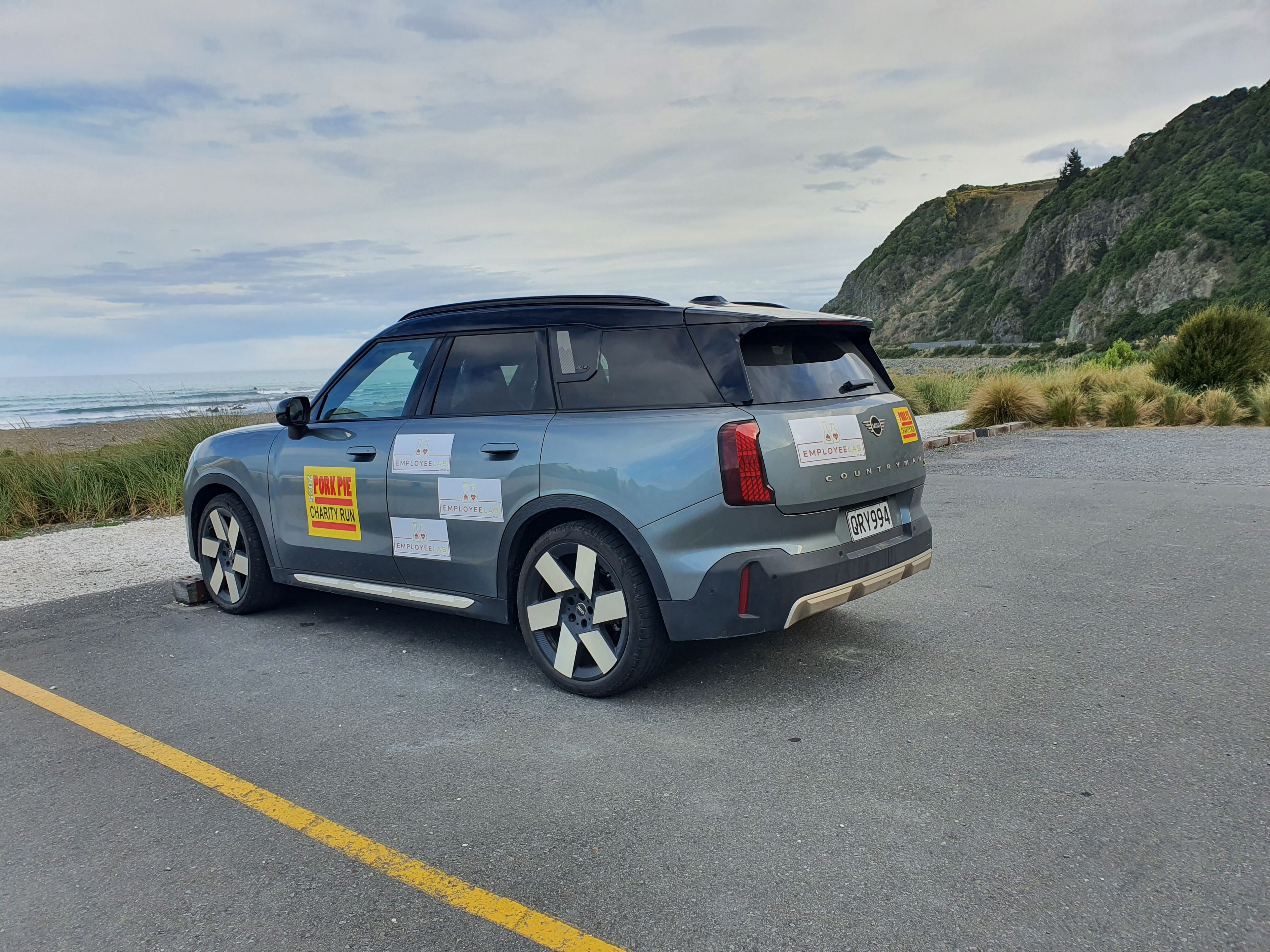 A 2025 Mini Countryman SE All4 with the ocean in the background, taken just outside Kaikoura.