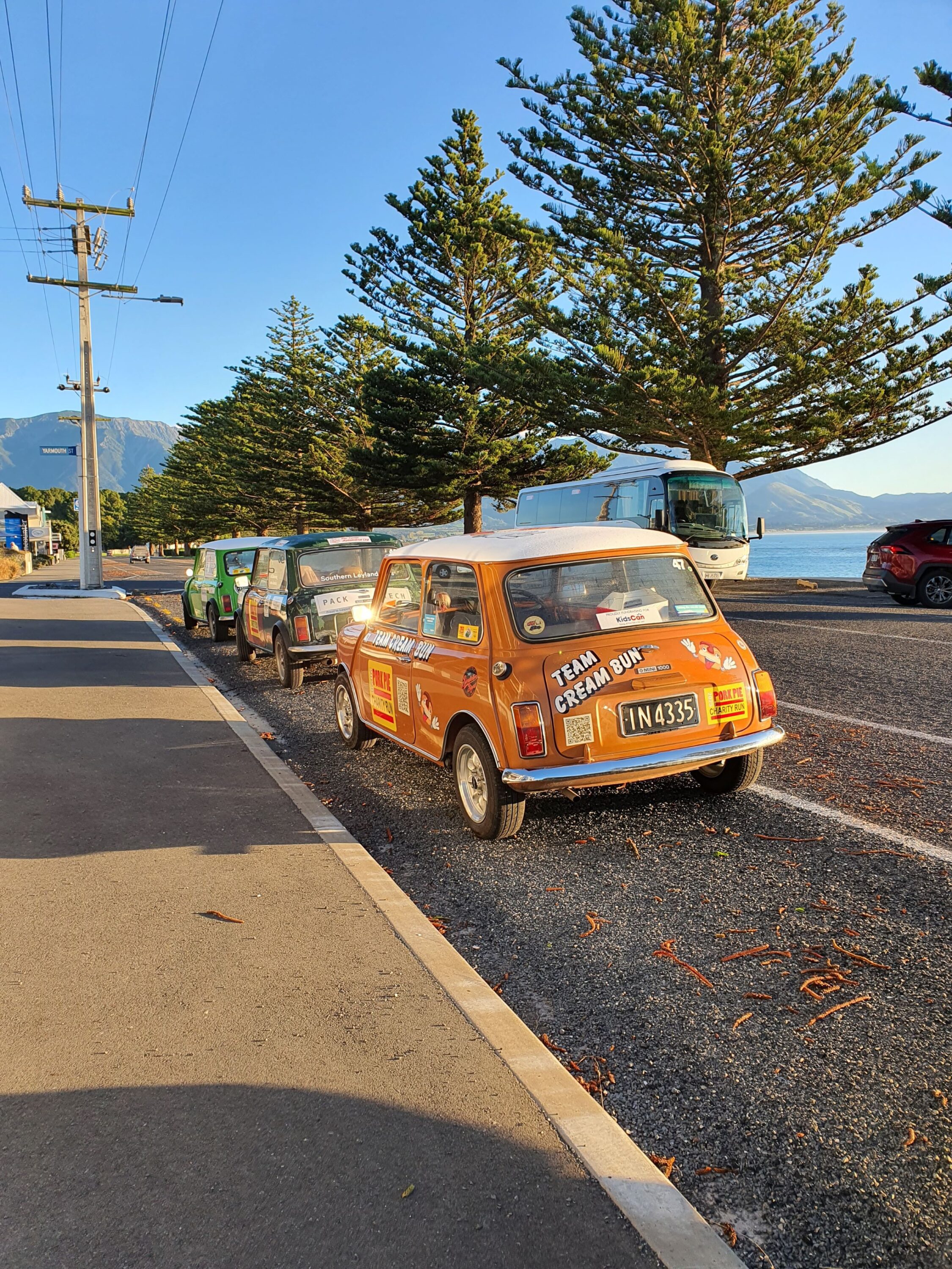 Three classic Minis parked outside the hotel on Kaikoura's main road. Teams 'Cream Bun', 'Southern Leyland Lads' and 'Low n Slow' pictured on the 2025 Pork Pie Charity Run.