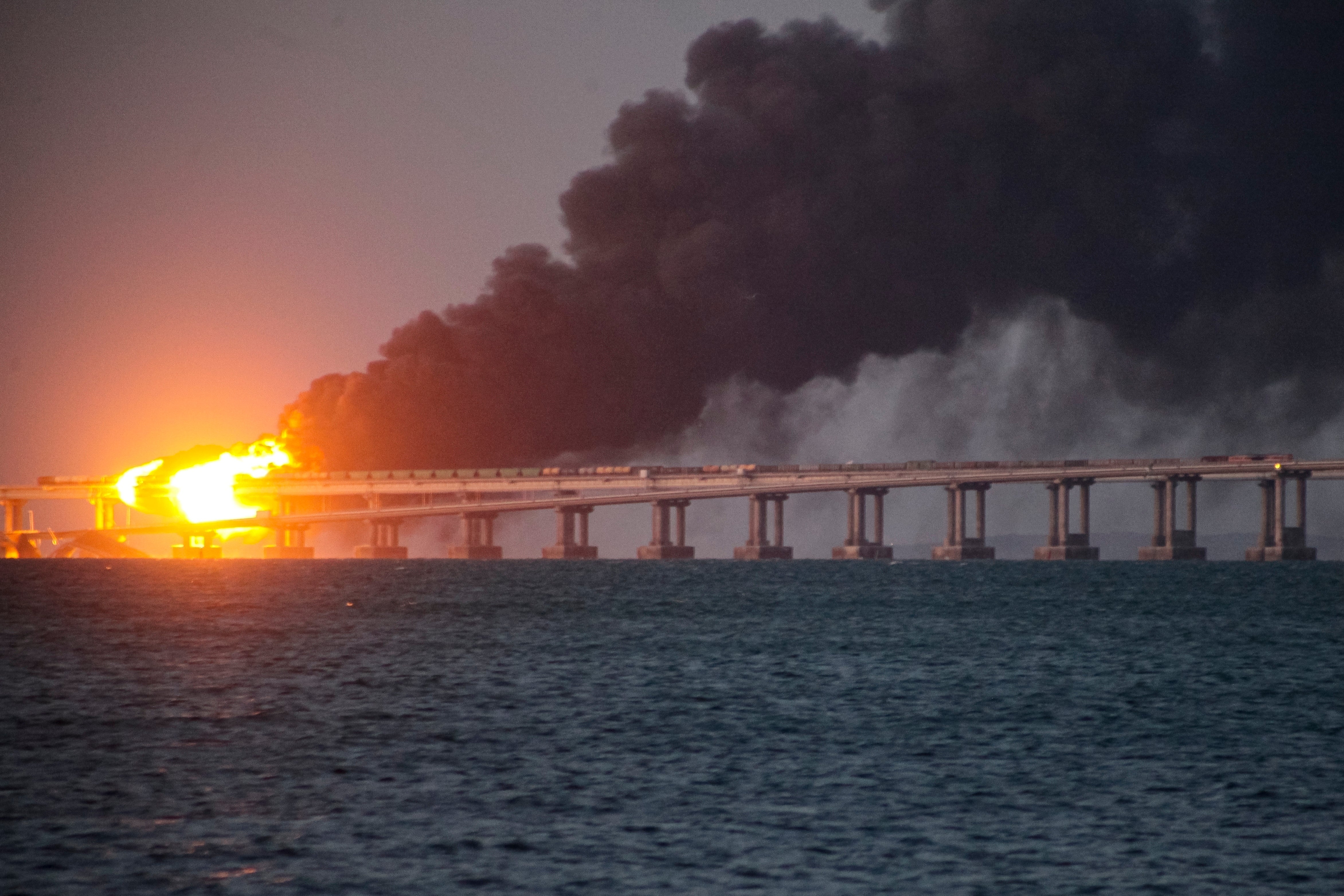 FILE - Flames and smoke rise from a bridge connecting Crimea and Russia in Kerch, on the Crimean peninsula, Oct 8, 2022