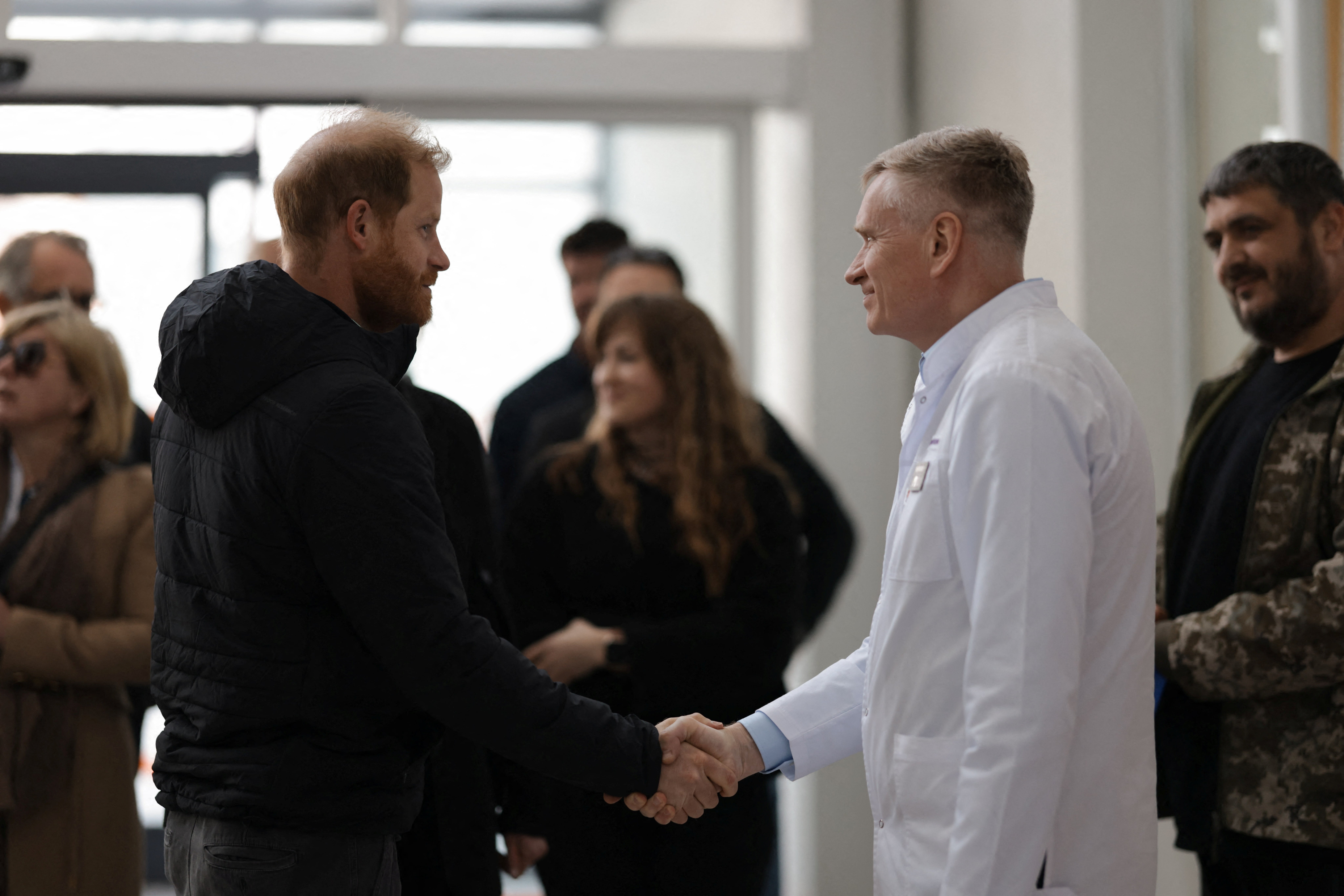 Prince Harry shakes hands with a member of medical staff as he visits the Superhumans Centre in Lviv