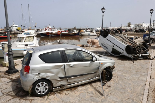 A view of damaged cars after a powerful storm which has triggered widespread flooding at the port of Naousa, on the Aegean Sea island of Paros, Greece, Tuesday, April 1, 2025. (John Liakos/InTime News via AP)
