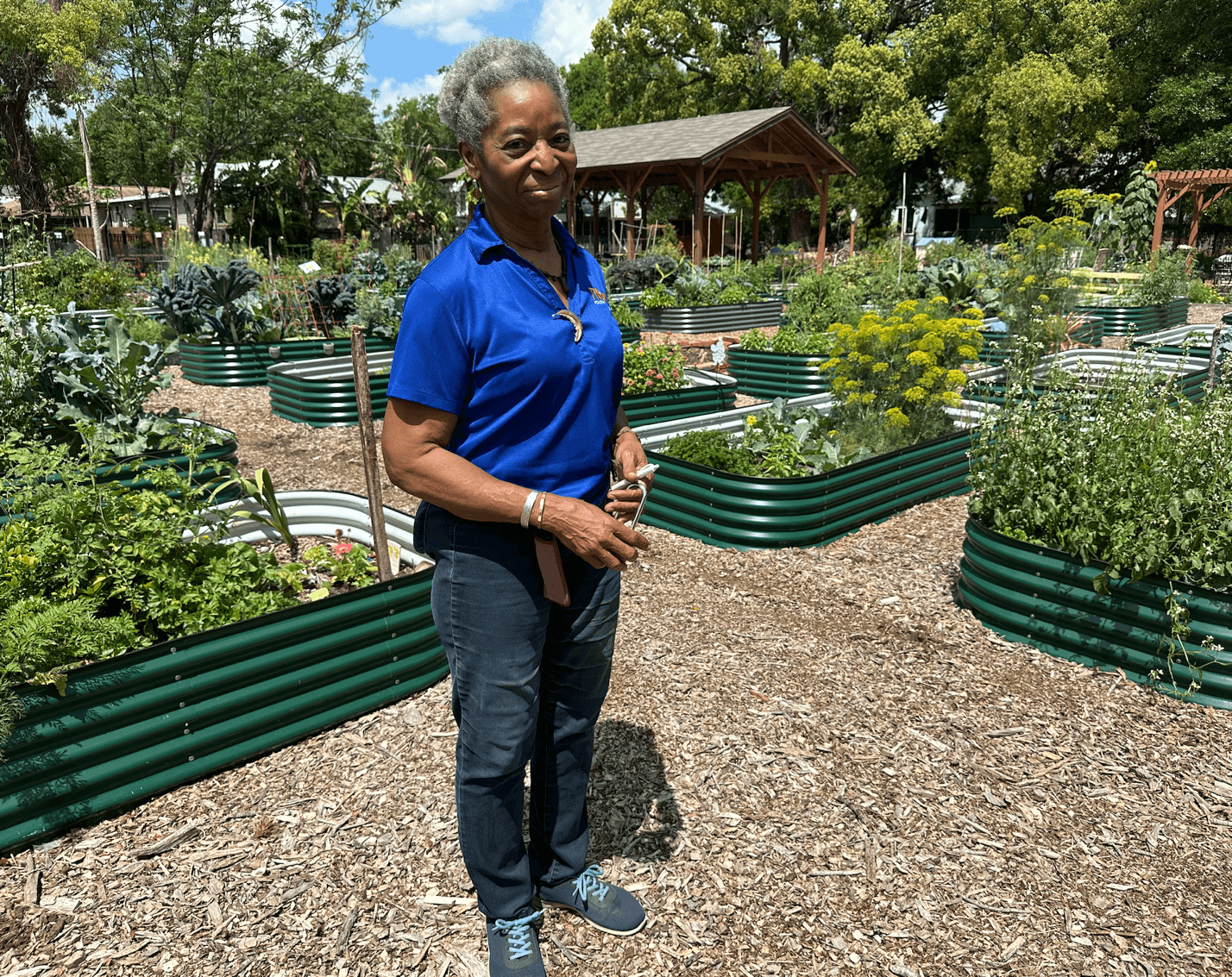 A person standing in a garden Description automatically generated