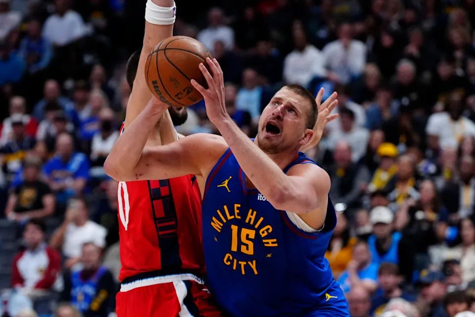 Denver Nuggets center Nikola Jokic (15) drives around LA Clippers center Ivica Zubac (40) in the second half at Ball Arena.© Ron Chenoy-Imagn Images