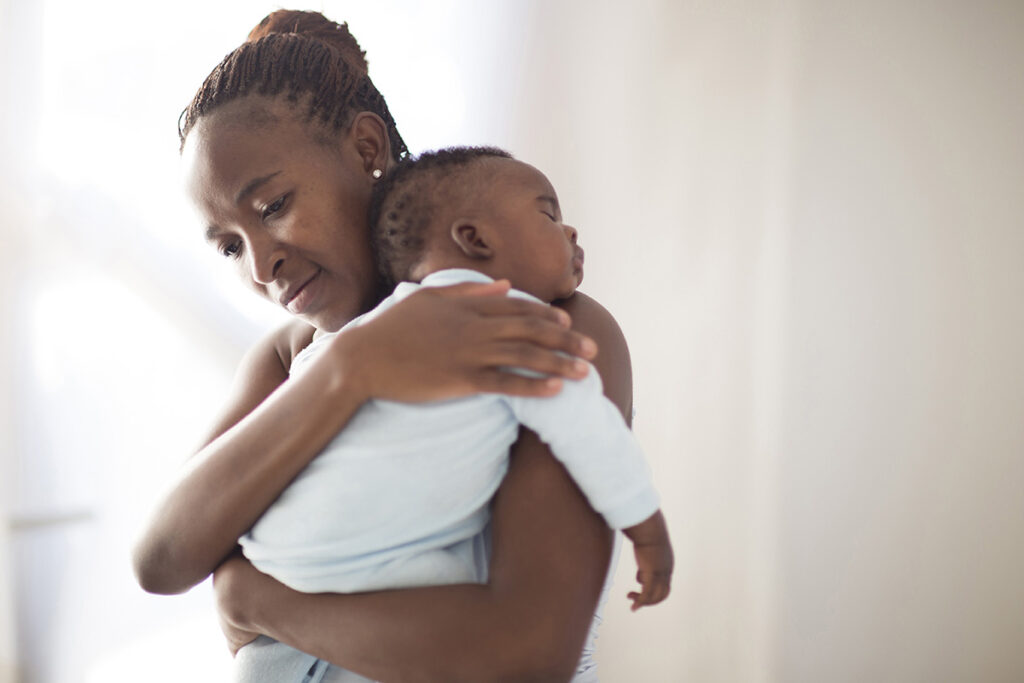 Penn State Health Obstetrics and Gynecology presents Black maternal health events April 16 A Black mother holds her sleeping baby on her shoulder.