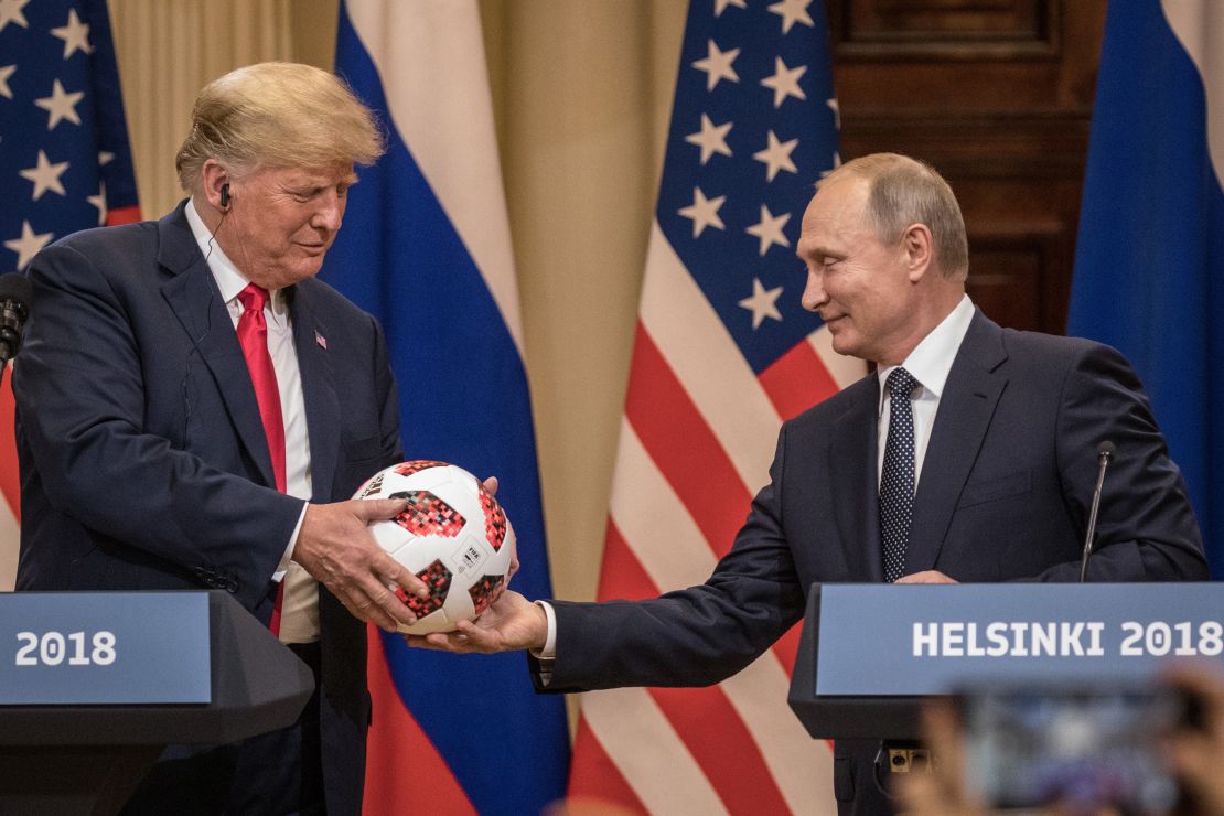 Russian President Vladimir Putin hands US President Donald Trump a World Cup football on July 16, 2018 in Helsinki, Finland.