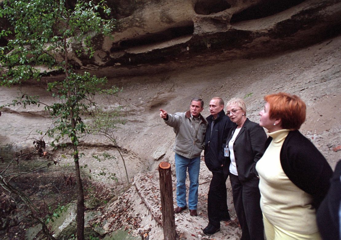 US President George W. Bush and Russian President Vladimir Putin tour a canyon and waterfall at the Bush Ranch November 14, 2001 in Crawford, Texas.