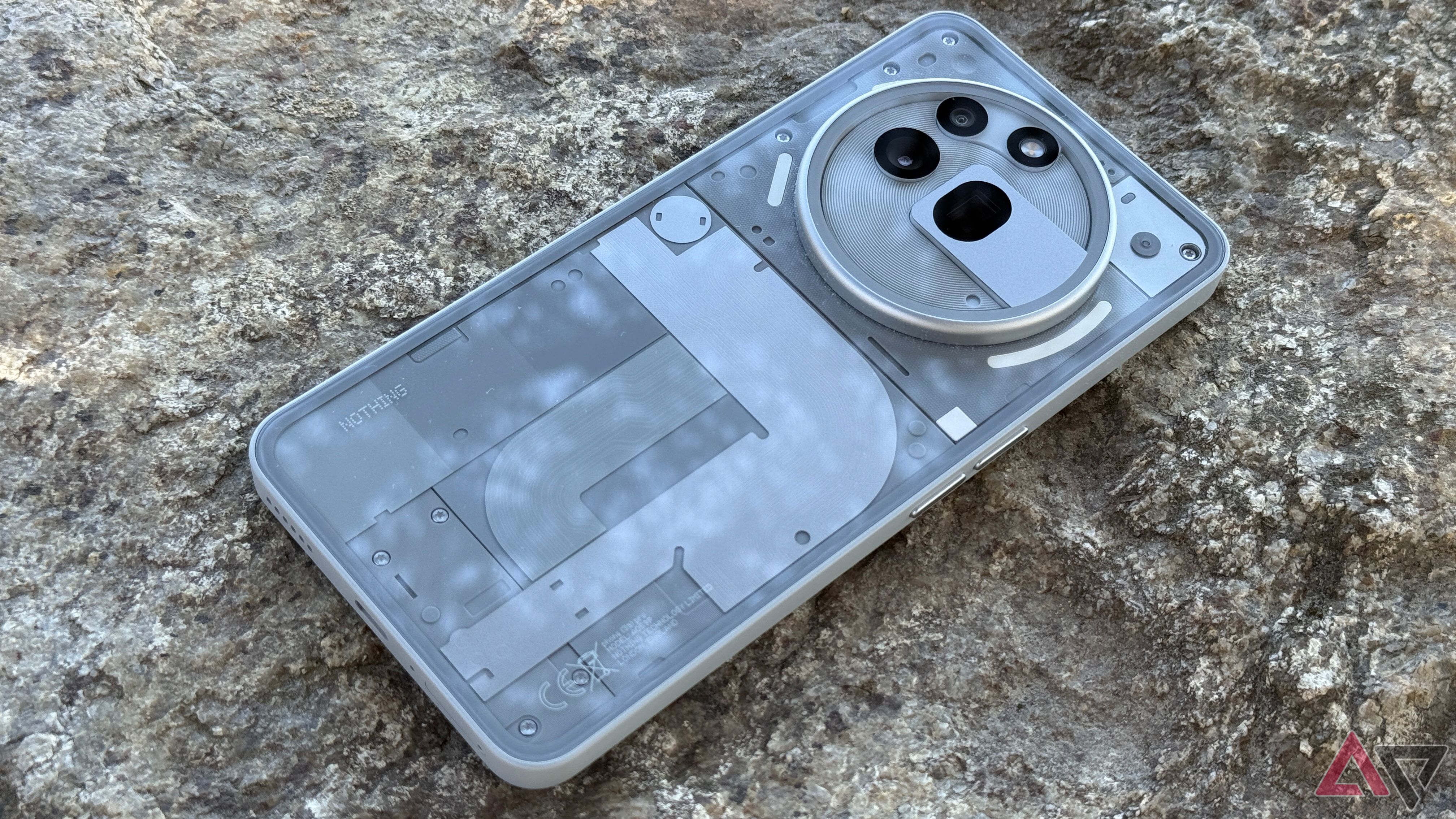 Nothing Phone 3a Pro in gray sitting on a rock