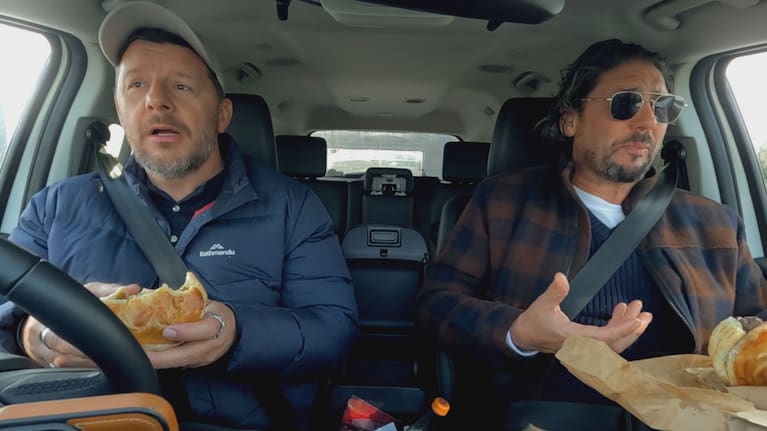 Manu Feildel and Colin Fassnidge having a classic Kiwi experience – pies on a road trip.