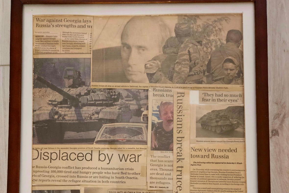 Old yellowed newspaper clippings in a frame.