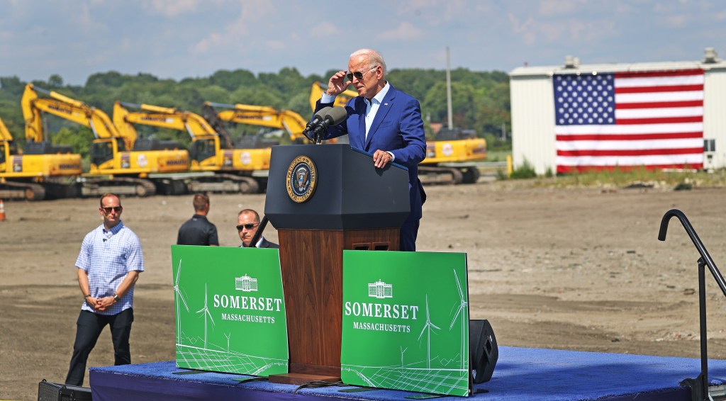 President Joe Biden standing at a podium delivering remarks on tackling the climate crisis at the former Brayton Point power plant in Somerset, MA.