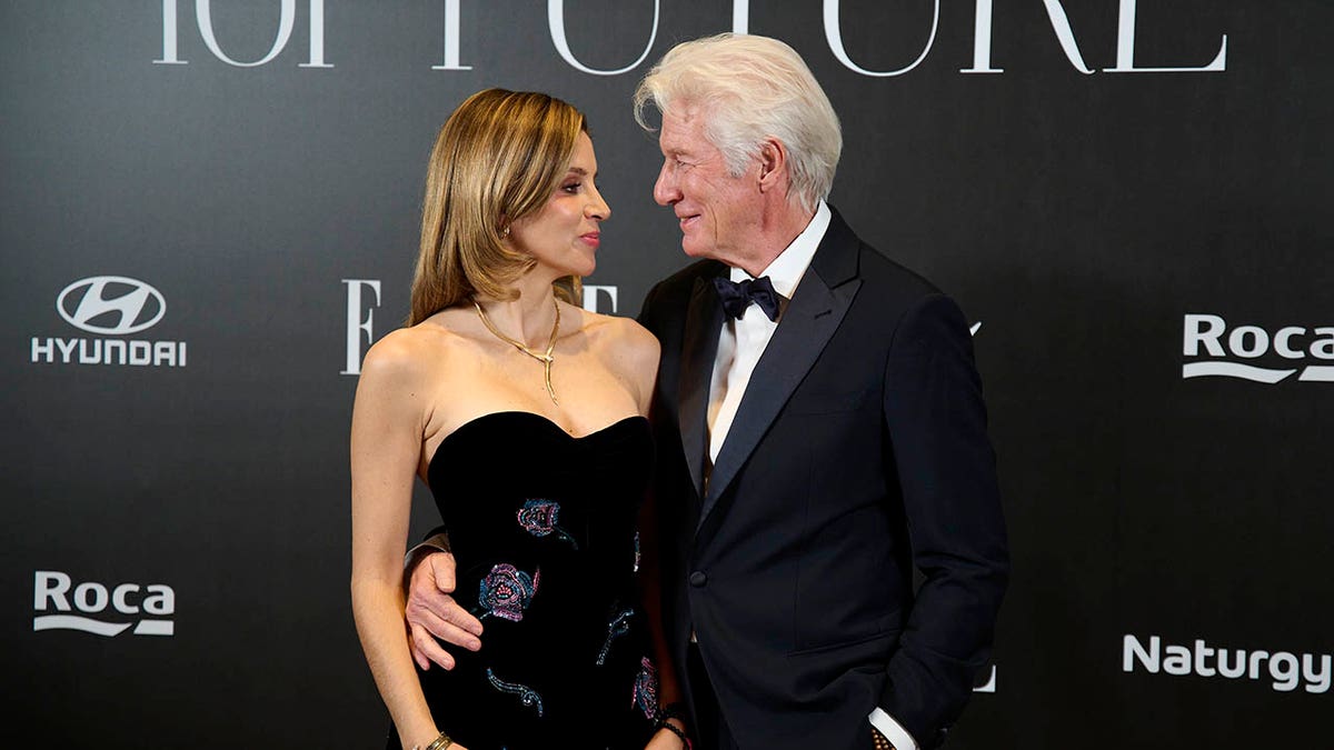RIchard Gere and wife Alejandra looking at each other