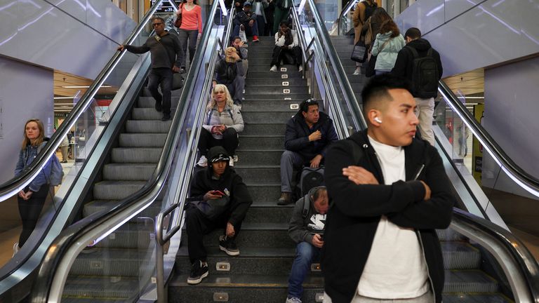 People wait on a platform as metro operations resume in Madrid.
Pic: Reuters