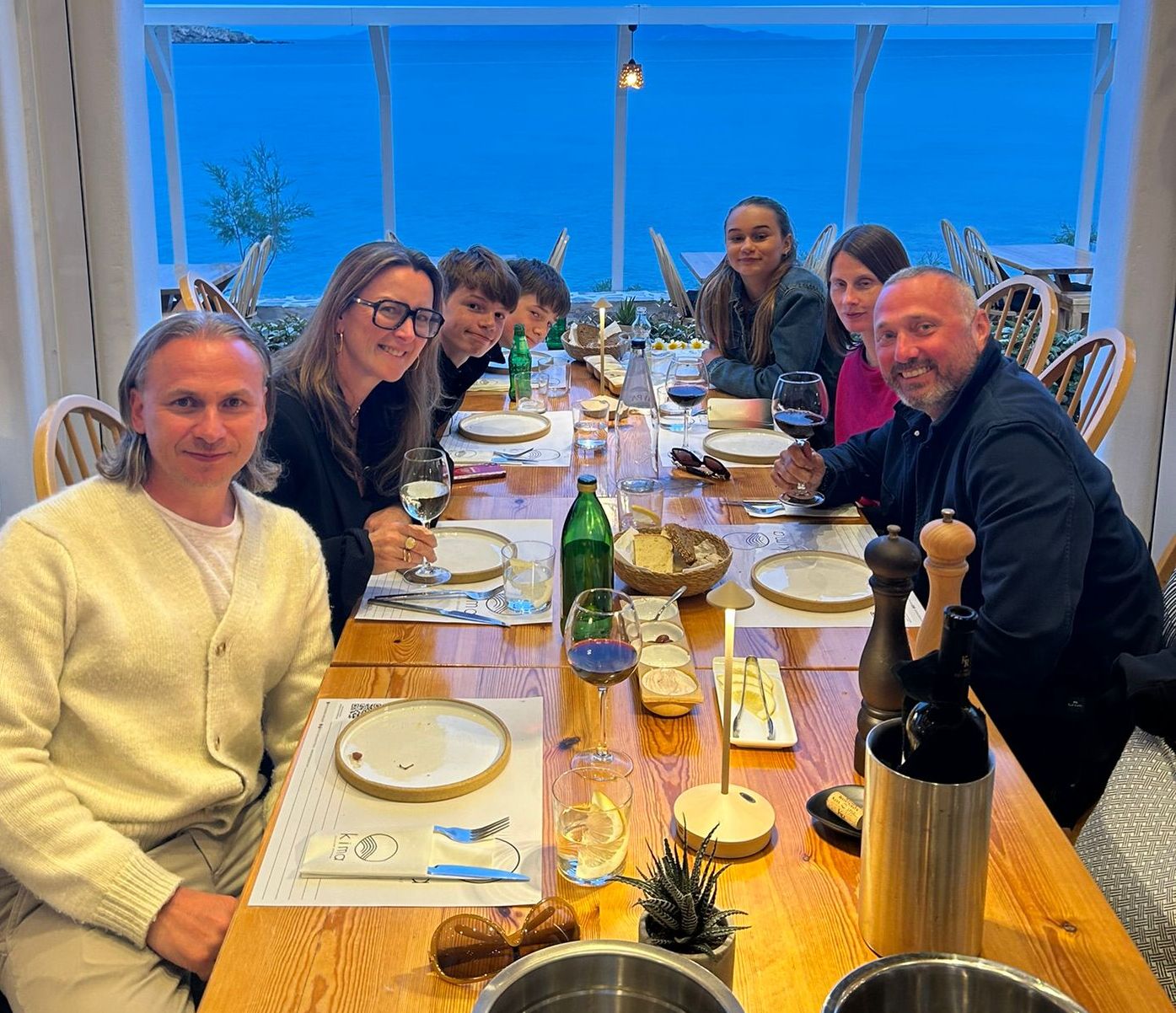 Family dining at a restaurant with an ocean view.