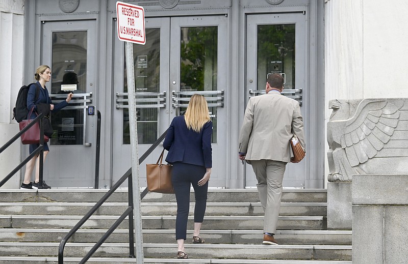 Staff photo by Abby White / Defense attorneys Logan Davis, left, and Bryan Hoss enter the Chattanooga federal courthouse for Sead Miljkovic's trial. Miljkovic was found not guilty Friday of the torture charges against him.