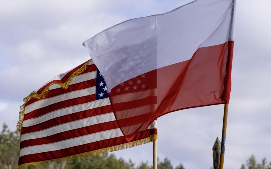 The U.S. and Polish flags fly side by side.
