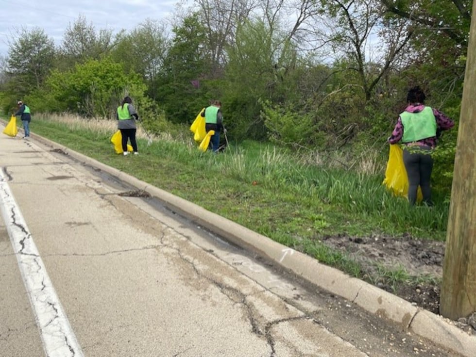 Volunteers work to help the environment by cleaning up along Keith Creek