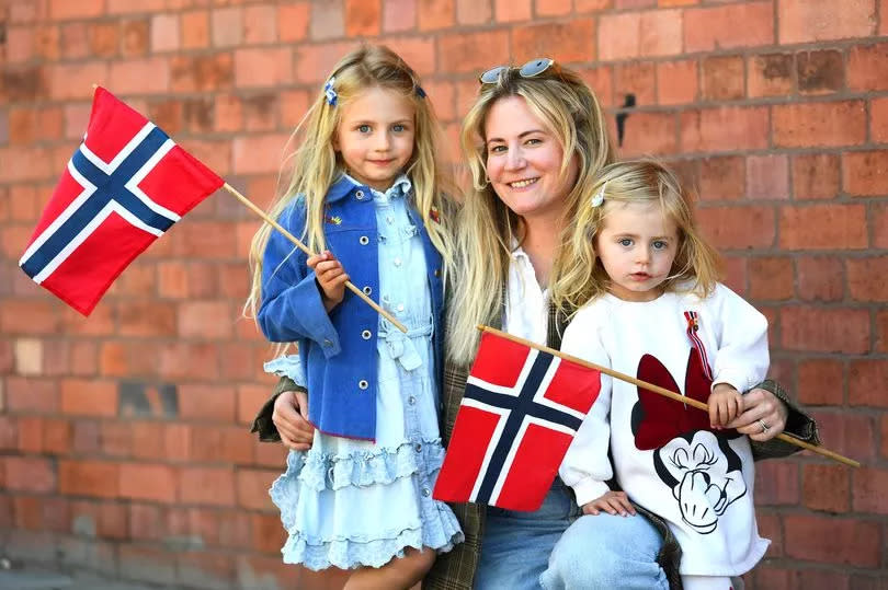 Mari Lunde and her daughters Nola - aged five (left), and Cora -aged two, at the Norwegian Constitution Day celebrations