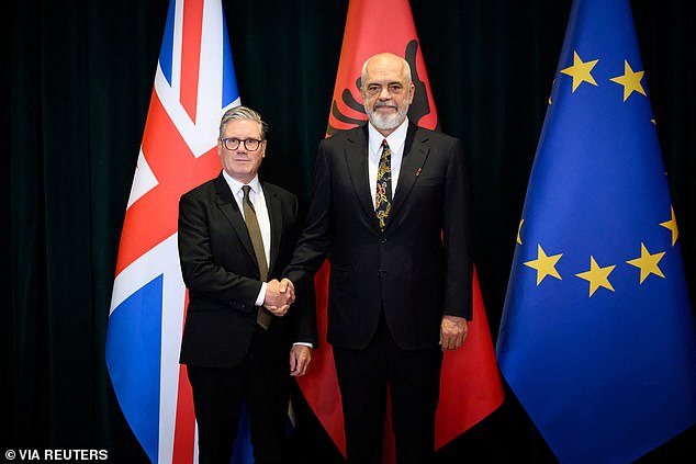 Shaking hands in front of the Union Jack and Albanian flags, there was a notable disparity between the two leaders