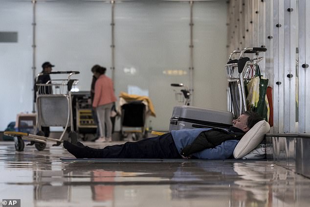 A person sleeps on the floor of Terminal 4 at Adolfo SuÃ¡rez-Madrid Barajas Airport in Madrid, Spain, Monday, May 12, 2025