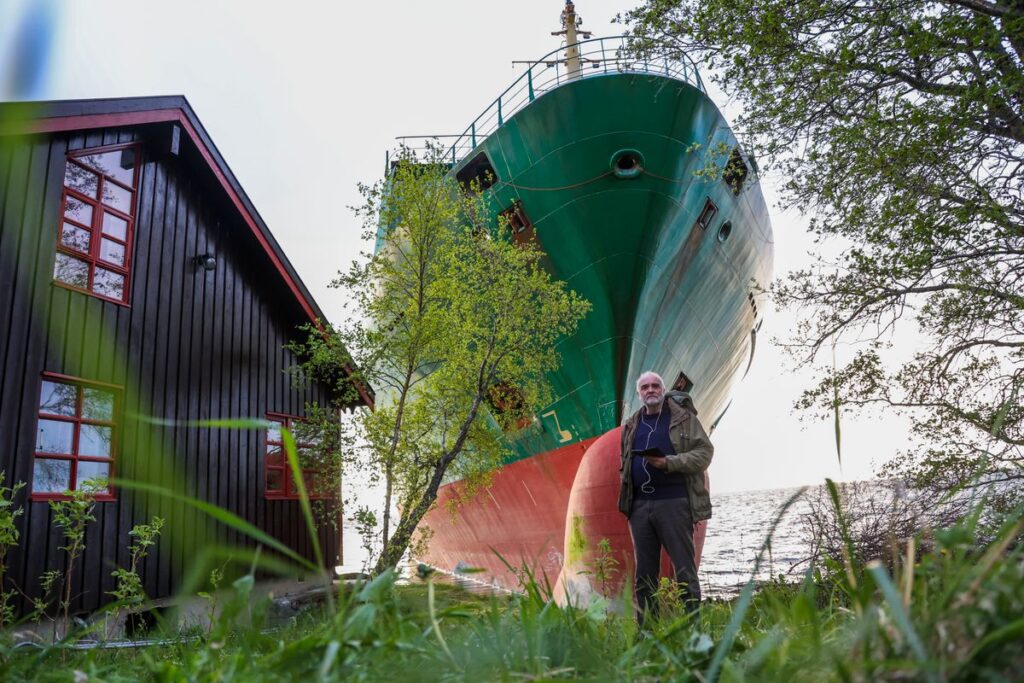 A cargo ship that ran aground in Norway, narrowly missing a house, is being towed to a nearby harbor