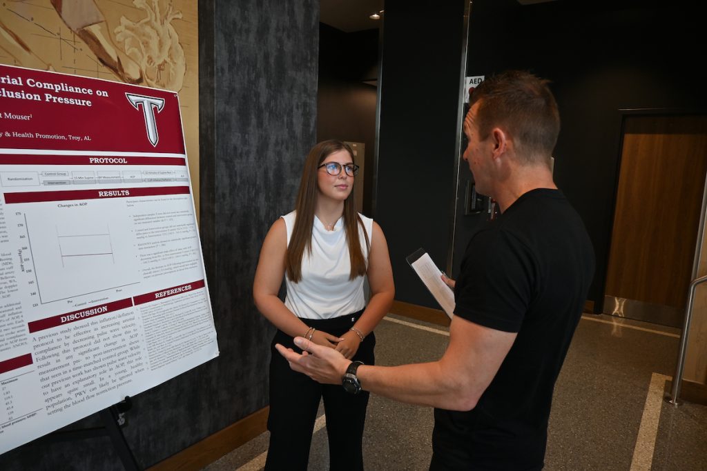 Ashlyn Shaver talking with Dr. Michael Green about her presentation