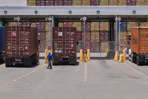 A worker traverses the entrance of a shipping terminal in San Juan, Puerto Rico, Thursday, May 8, 2025. (AP Photo/Alejandro Granadillo)