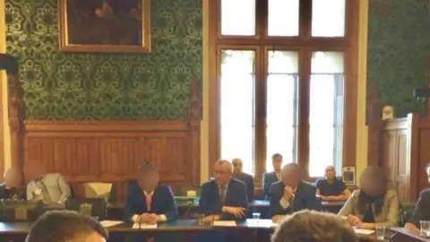 Facebook Three convicted spies, sat behind a former Bulgarian politician, Georgi Pirinski, at an event in the House of Commons 