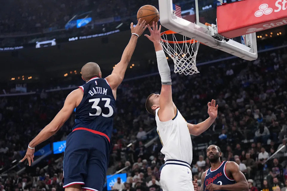 Clippers forward Nicolas Batum (33) blocks a shot by Nuggets center Nikola Jokic (15).Kirby Lee-Imagn Images