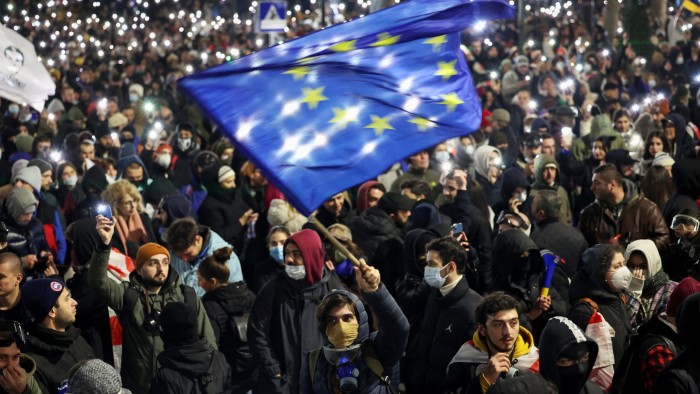 A man waves an EU flag at a protest near Georgia’s parliament building in Tbilisi