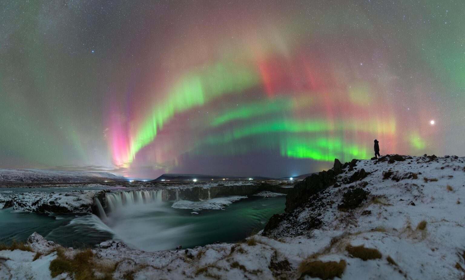 I captured a pink aurora panorama above Goðafoss, the Waterfall of the Gods