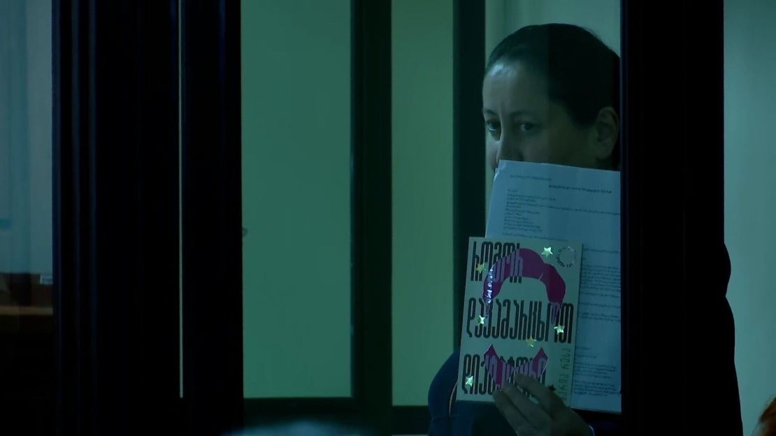 Mzia Amaglobeli is seen in court, holding a book by Nobel Prize-winning journalist Maria Ressa, titled 
