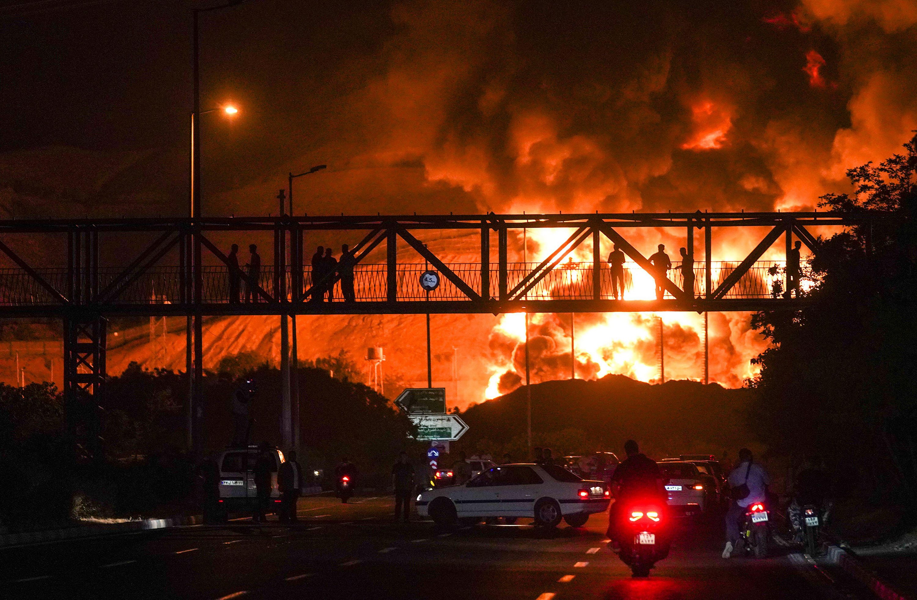 Fire and smoke rise from an oil refinery in Tehran following an Israeli airstrike.