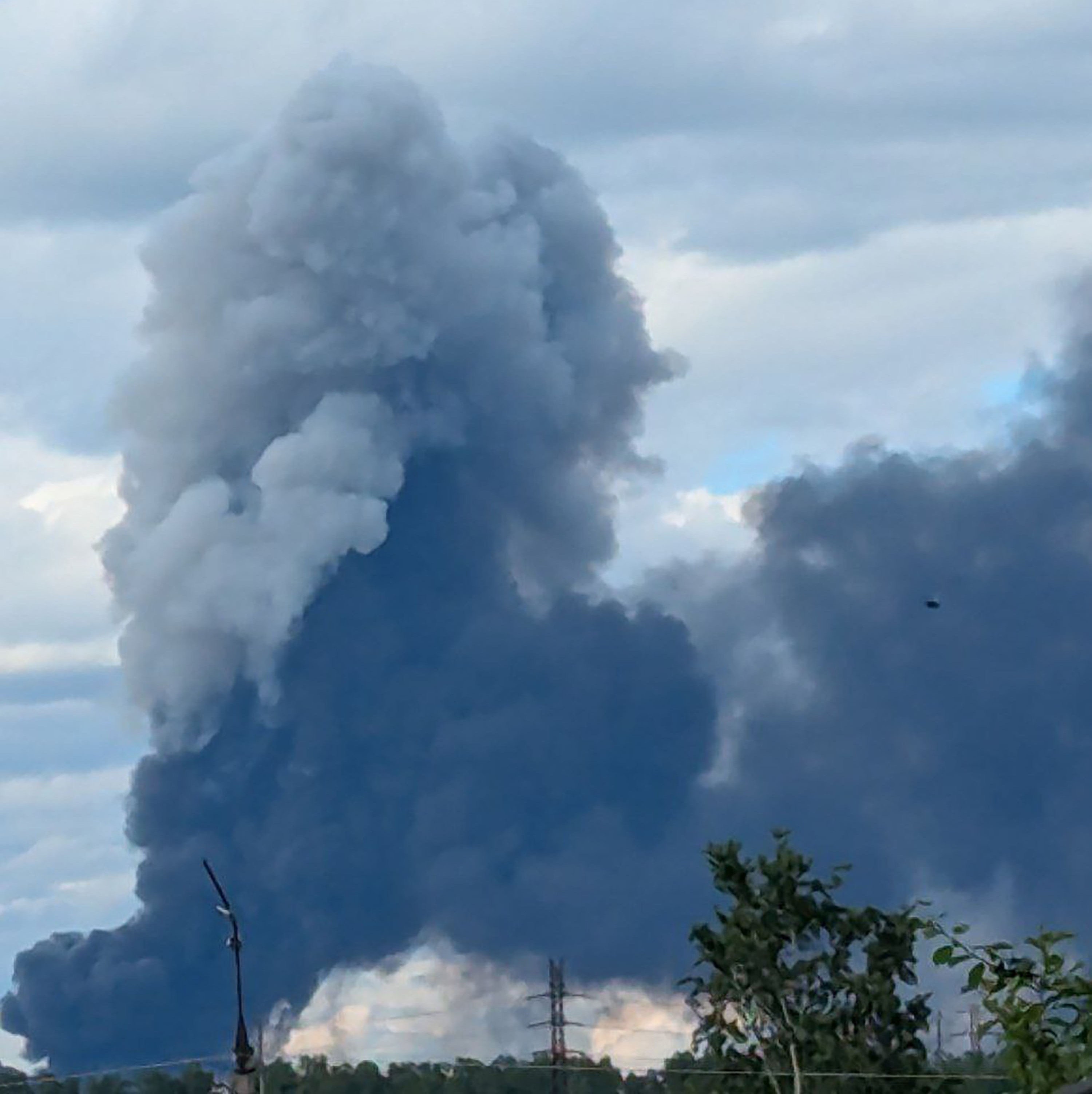 Large plume of smoke rising from a fire.