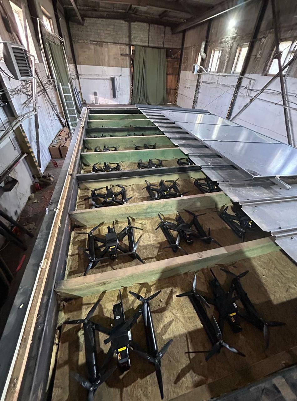 Many drones stored in a warehouse.