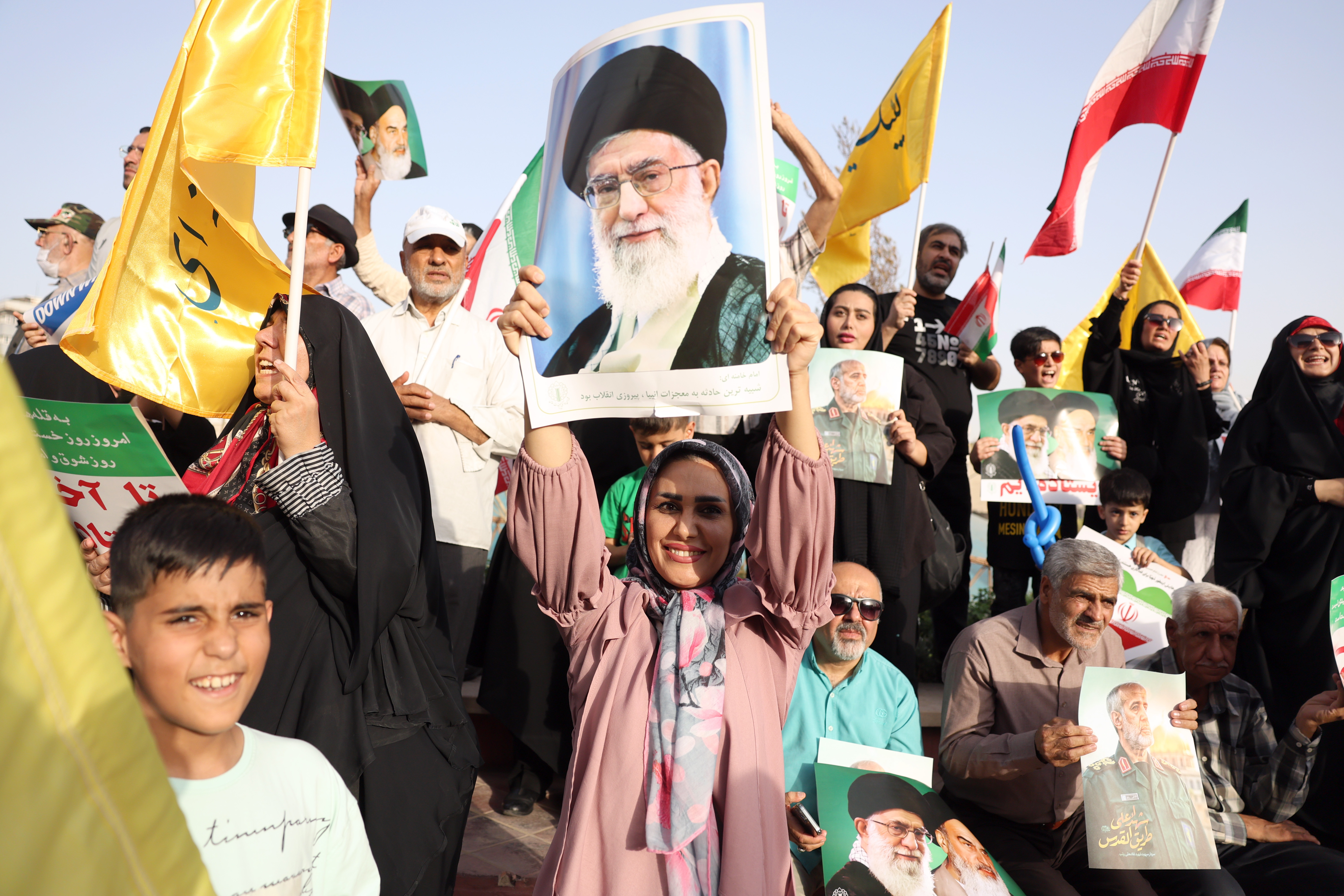 Iranians holding portraits of Ayatollah Ali Khamenei at a rally in Tehran.