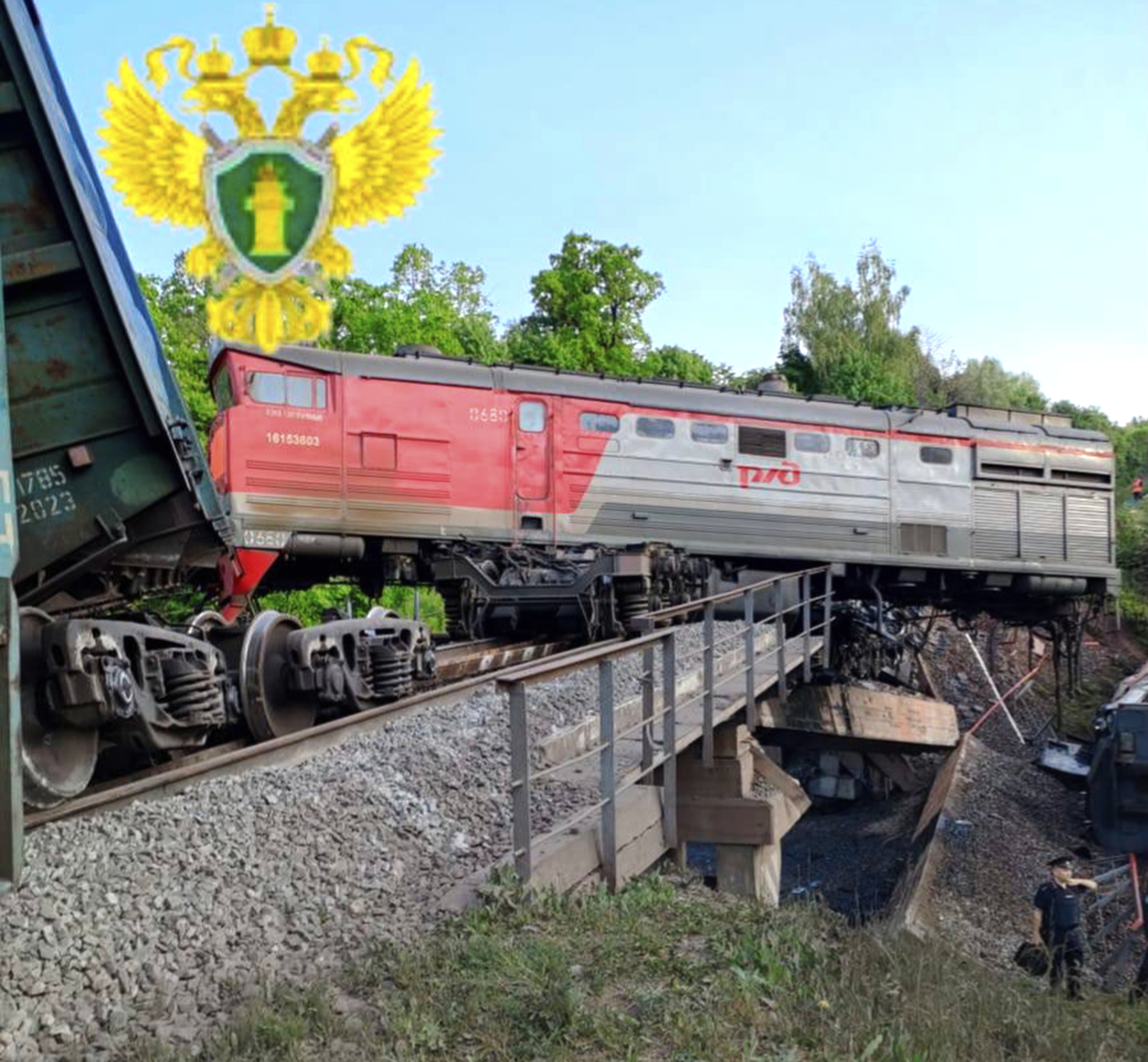 Damaged bridge and derailed freight train in Russia's Kursk region.