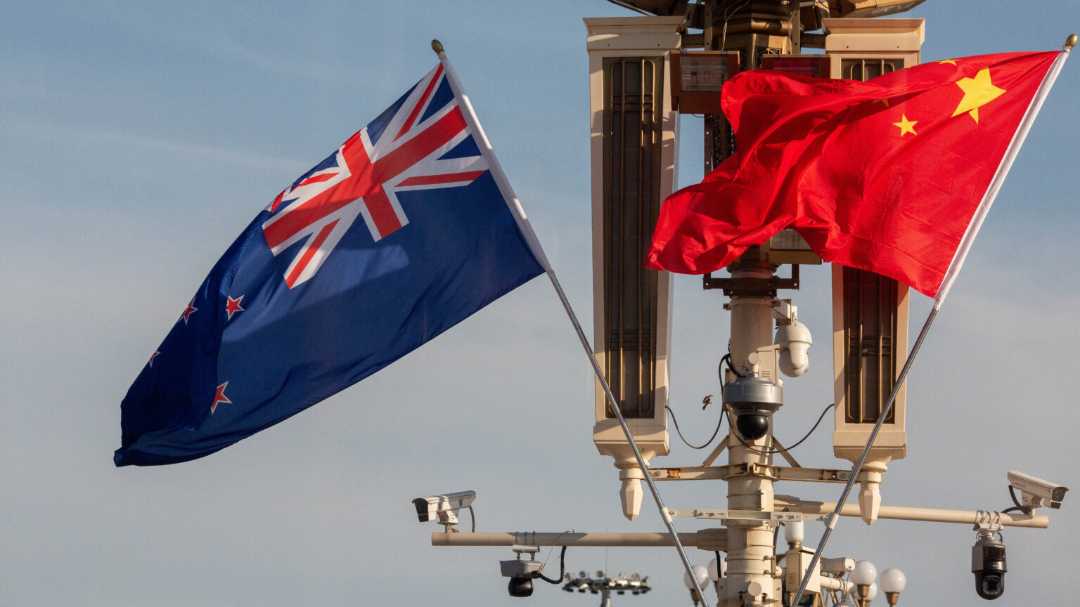 New Zealand and China's flag fly outside the Great Hall of the People