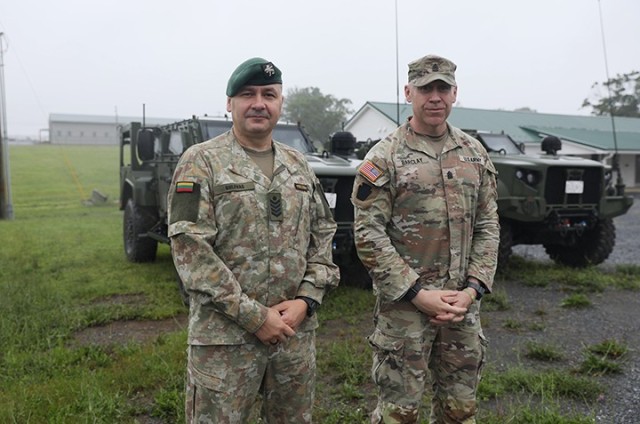 Lithuanian Command Sgt. Maj. Ruslanas Gulevas, senior enlisted leader of the Grand Duke Algirdas Infantry Battalion, Lithuanian Land Forces, left, and U.S. Army Command Sgt. Maj. Jason L. Barclay, senior enlisted advisor for 1st Battalion, 111th...