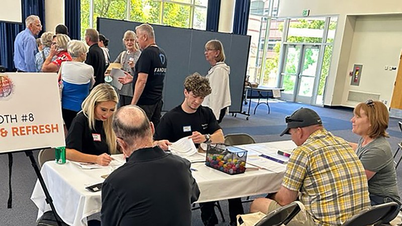 People attend an informational fair.