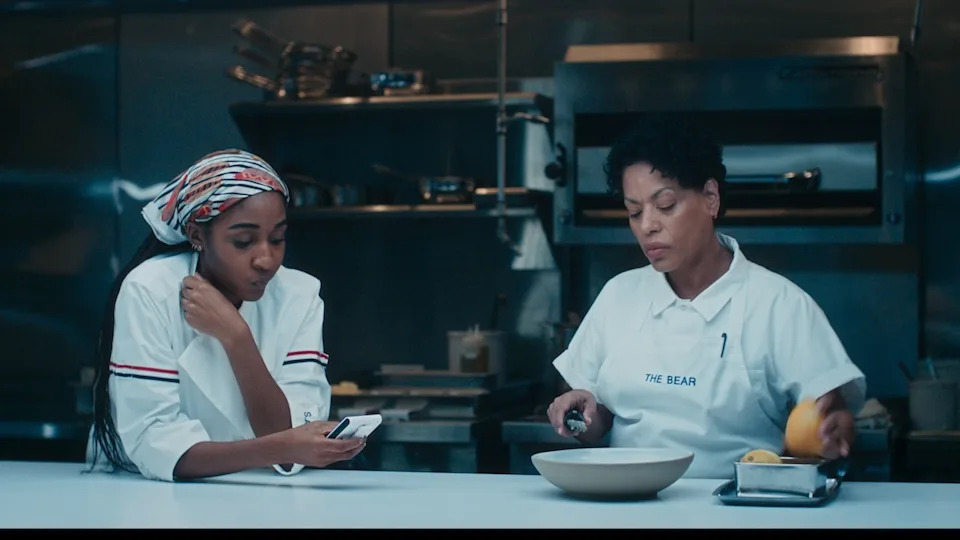 'The Bear' Season 4 stars (l-r)  Ayo Edebiri as Sydney Adamu, Liza Colon-Zayas as Tina, shown here working in the kitchen
