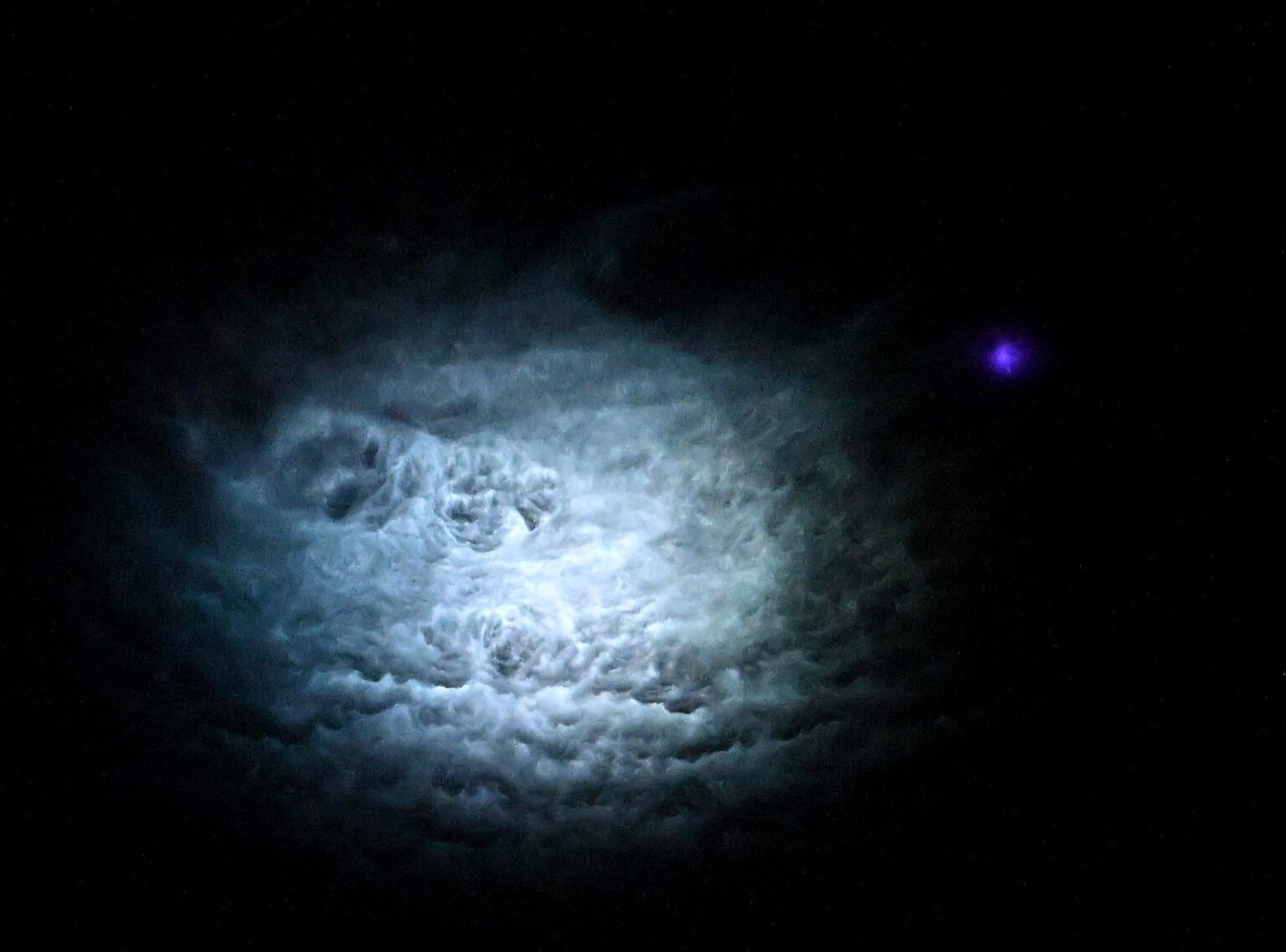 Nadir view of a blue jet from the International Space Station, details in comments.